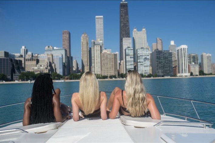 Guests aboard a private yacht taking in the Chicago skyline